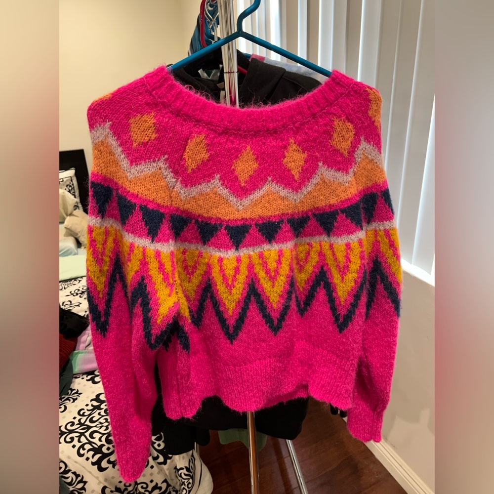 Bright pink sweater with festive bright design